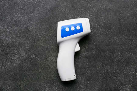 Infrared thermometer on dark backgroundの写真素材