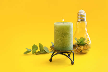 Composition with stylish candle on color backgroundの写真素材