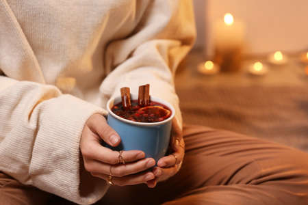 Woman with tasty mulled wine at home, closeupの写真素材