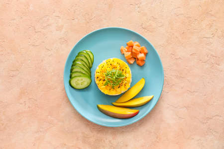 Plate of fresh mango salad on color background