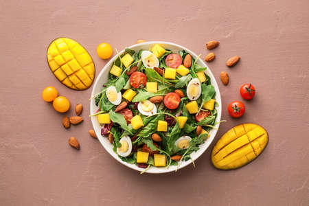 Plate of fresh mango salad on color backgroundの写真素材