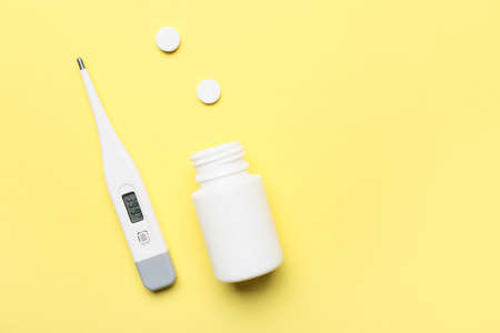 Thermometer and remedy on color background