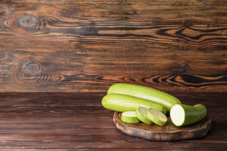 Cutting board with squash on wooden backgroundの写真素材