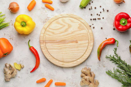 Cutting board with vegetables on light backgroundの写真素材