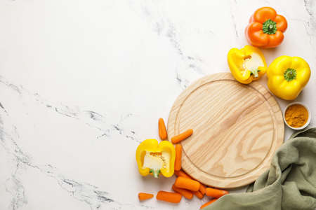 Cutting board with vegetables on light backgroundの写真素材