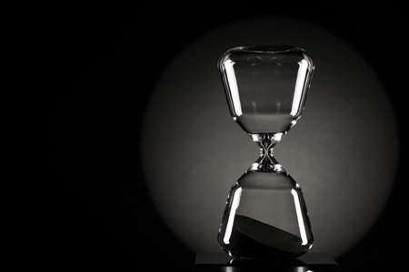 Stylish hourglass on dark background