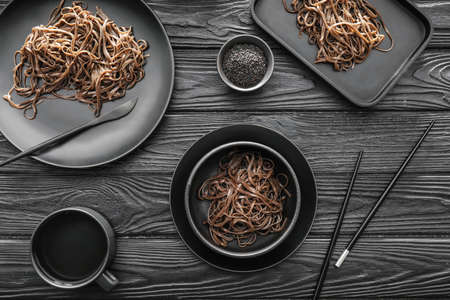 Plates with soba noodles on dark wooden backgroundの写真素材