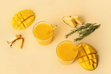 Glasses of tasty mango smoothie on color backgroundの写真素材