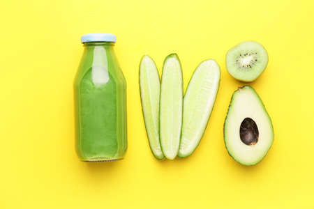 Composition with bottle of healthy green smoothie and ingredients on color backgroundの写真素材