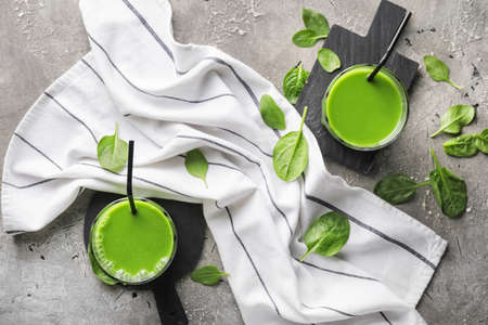 Glasses of healthy spinach smoothie on dark backgroundの写真素材