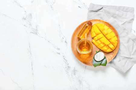 Composition with mango essential oil on light backgroundの写真素材