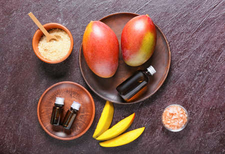 Composition with mango essential oil and sea salt on dark backgroundの写真素材