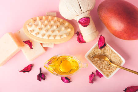 Composition with mango essential oil and bath supplies on color backgroundの写真素材