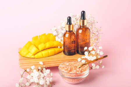 Composition with mango essential oil and sea salt on color backgroundの写真素材