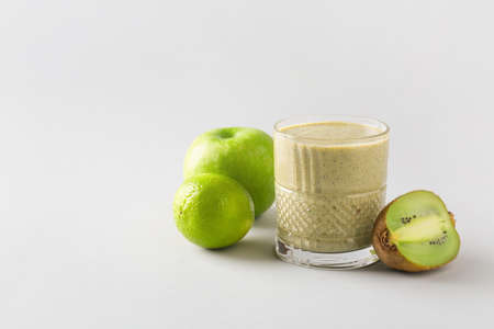 Glass of tasty smoothie on light backgroundの写真素材