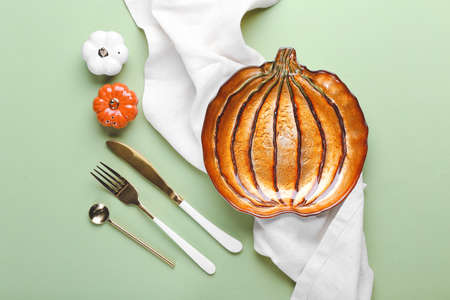 Beautiful table setting for Thanksgiving Day celebration on color backgroundの写真素材