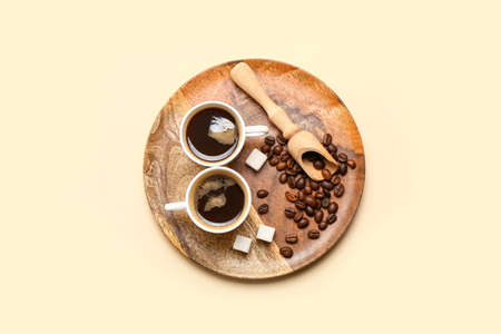 Cups of hot coffee on color backgroundの写真素材