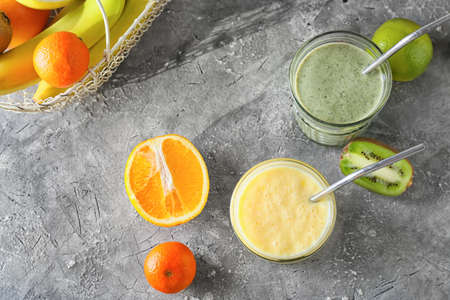 Glasses of tasty fruit smoothie on grunge backgroundの写真素材