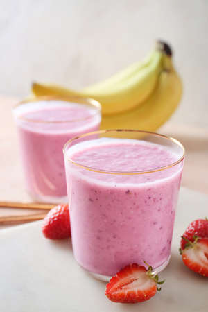 Glasses of tasty berry smoothie on color backgroundの写真素材