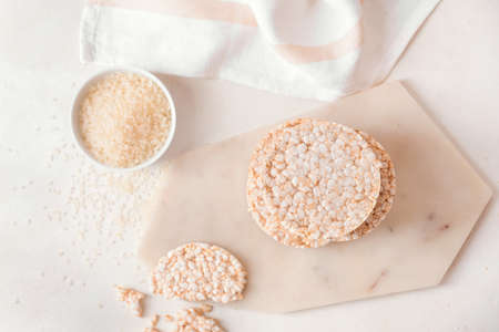 Stack of rice crackers on light backgroundの写真素材