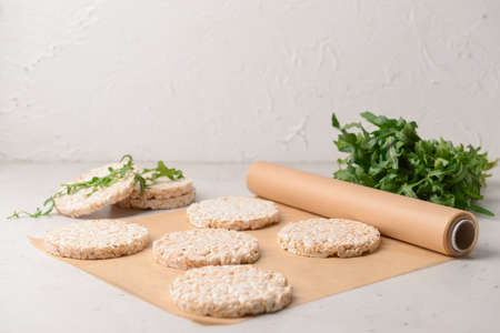 Parchment with rice crackers on light backgroundの写真素材