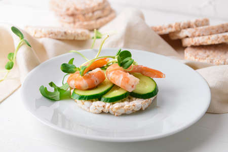 Rice cracker with cucumber and shrimp on light backgroundの写真素材