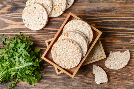 Box with rice crackers on wooden backgroundの写真素材
