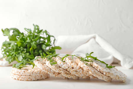 Rice crackers with arugula on light backgroundの写真素材