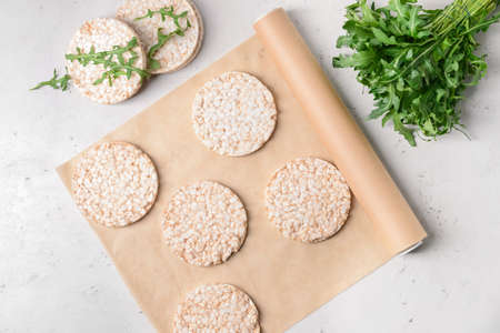 Parchment with rice crackers on light backgroundの写真素材