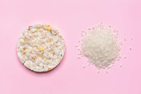 Tasty cracker and heap of rice on color backgroundの写真素材