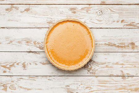 Tasty pumpkin pie on wooden background, top viewの写真素材