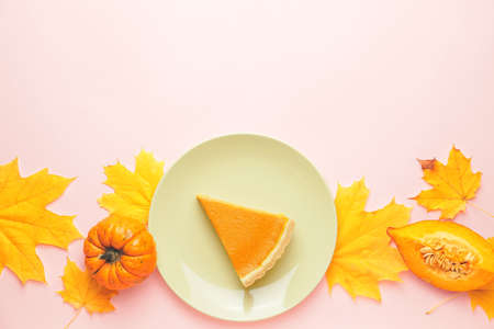 Composition with slice of tasty pumpkin pie on color backgroundの写真素材