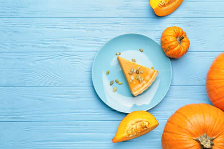 Composition with tasty cut pumpkin pie on wooden backgroundの写真素材