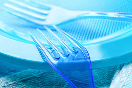 Plastic forks and plate on color background, closeupの写真素材
