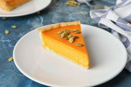 Plate with slice of tasty pumpkin pie on tableの写真素材