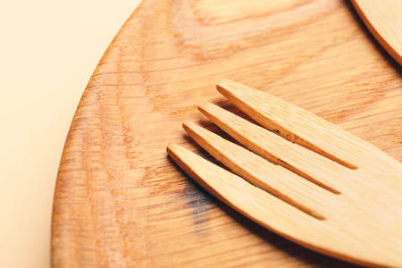 Wooden fork on color background, closeupの写真素材