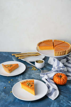 Composition with tasty cut pumpkin pie on tableの写真素材