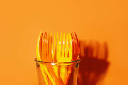 Plastic forks on color backgroundの写真素材
