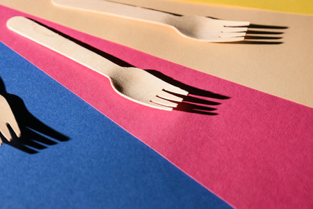 Wooden forks on color backgroundの写真素材