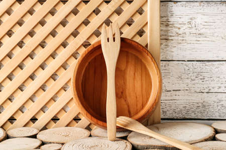 Wooden forks and bowl on wooden backgroundの写真素材