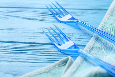 Plastic forks on color wooden backgroundの写真素材