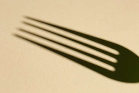 Shadow of fork on color backgroundの写真素材