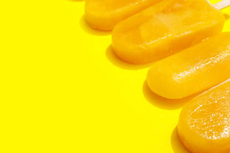 Tasty mango ice cream on color backgroundの写真素材