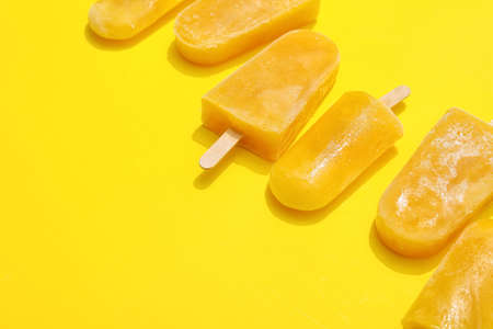 Tasty mango ice cream on color backgroundの写真素材