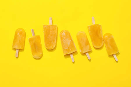 Tasty mango ice cream on color background