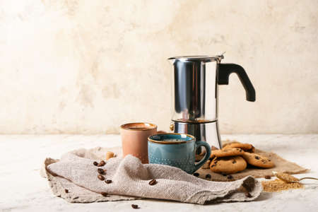 Composition with cups of tasty coffee and cookies on light backgroundの写真素材