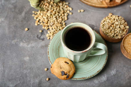 Composition with cup of tasty coffee and beans on gray backgroundの写真素材