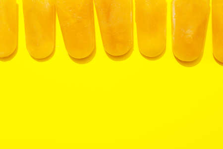 Tasty mango ice cream on color backgroundの写真素材