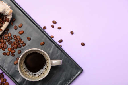 Composition with cup of tasty coffee and beans on color backgroundの写真素材