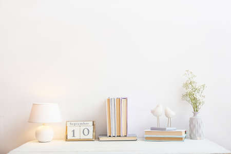 Stack of books and decor on table in roomの写真素材